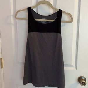 Five tank tops that are either size S or M.